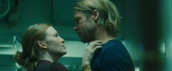 Movie still from “World War Z” (2013), directed by Marc Forster – A man and a woman standing next to each other; Close Up shot, Low angle