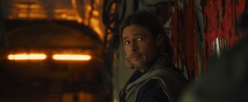 Movie still from “World War Z” (2013), directed by Marc Forster – A man with long hair and a beard is looking into the distance; Close Up shot, Over the shoulder angle