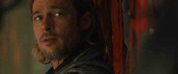 Movie still from “World War Z” (2013), directed by Marc Forster – A person with long hair and a beard; Close Up shot, Over the shoulder angle