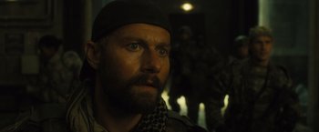 Movie still from “World War Z” (2013), directed by Marc Forster – A person with a beard wearing a hat; Close Up shot, Over the shoulder angle