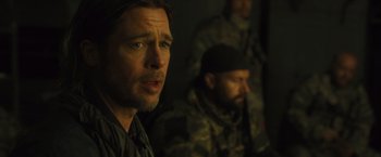 Movie still from “World War Z” (2013), directed by Marc Forster – A man with a goatee is looking at the camera; Close Up shot, Over the shoulder angle