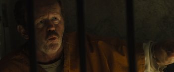 Movie still from “World War Z” (2013), directed by Marc Forster – A person in a yellow jacket; Close Up shot, Over the shoulder angle