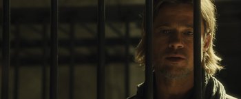 Movie still from “World War Z” (2013), directed by Marc Forster – A person behind a metal fence; Close Up shot, Low angle