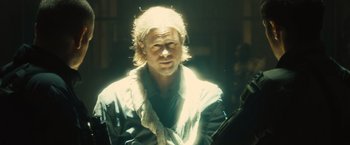 Movie still from “World War Z” (2013), directed by Marc Forster – A man with long white hair is looking at the camera; Close Up shot, Low angle