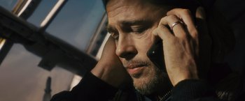 Movie still from “World War Z” (2013), directed by Marc Forster – A person talking on a cell phone; Close Up shot, Low angle