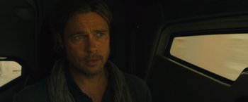 Movie still from “World War Z” (2013), directed by Marc Forster – A man with long blonde hair sitting in a car; Close Up shot, Over the shoulder angle