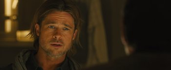 Movie still from “World War Z” (2013), directed by Marc Forster – A person with long hair and a beard; Close Up shot, Over the shoulder angle