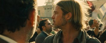 Movie still from “World War Z” (2013), directed by Marc Forster – A person with long blonde hair; Close Up shot, Over the shoulder angle