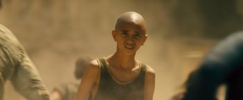 Movie still from “World War Z” (2013), directed by Marc Forster – A young man with a shaved head is posing for a picture; Close Up shot, High angle
