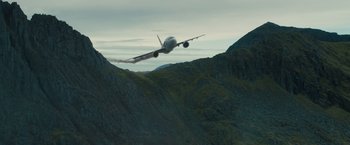 Movie still from “World War Z” (2013), directed by Marc Forster – An airplane is flying low over a mountain; Extreme Wide shot, Low angle