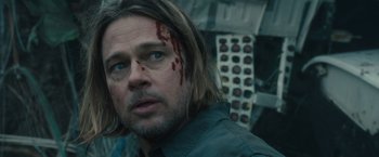 Movie still from “World War Z” (2013), directed by Marc Forster – A man with a bloody nose and a scar on his face; Close Up shot, Over the shoulder angle