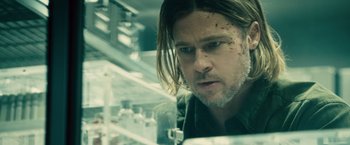 Movie still from “World War Z” (2013), directed by Marc Forster – A person with long hair; Close Up shot, Over the shoulder angle