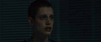 Movie still from “World War Z” (2013), directed by Marc Forster – A woman with short black hair is crying in the dark; Close Up shot, Over the shoulder angle
