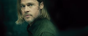 Movie still from “World War Z” (2013), directed by Marc Forster – A person wearing a green jacket; Close Up shot, Over the shoulder angle