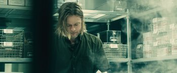 Movie still from “World War Z” (2013), directed by Marc Forster – A man with long hair and a beard standing in a kitchen; Medium shot, Low angle