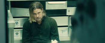 Movie still from “World War Z” (2013), directed by Marc Forster – A person with long hair; Medium shot, Over the shoulder angle
