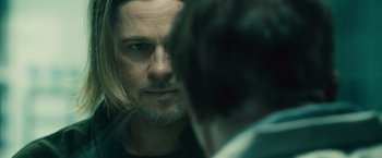 Movie still from “World War Z” (2013), directed by Marc Forster – A person with a beard; Close Up shot, Over the shoulder angle