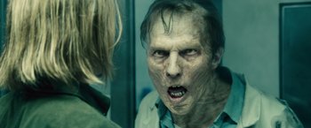 Movie still from “World War Z” (2013), directed by Marc Forster – A person with a zombie face; Close Up shot, Over the shoulder angle