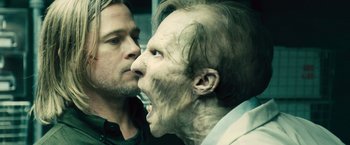 Movie still from “World War Z” (2013), directed by Marc Forster – Two men one of whom is a zombie and the other is a demon; Close Up shot, Over the shoulder angle