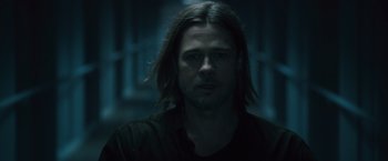 Movie still from “World War Z” (2013), directed by Marc Forster – A person with long black hair; Close Up shot, Low angle