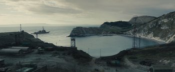 Movie still from “World War Z” (2013), directed by Marc Forster – A view of a body of water with a tower in the middle of it; Extreme Wide shot, High angle