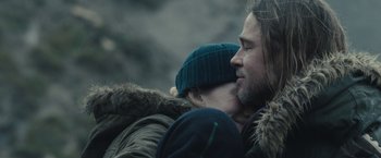 Movie still from “World War Z” (2013), directed by Marc Forster – A man and a woman are hugging each other; Close Up shot, Over the shoulder angle