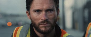 Movie still from “Wrath of Man” (2021), directed by Guy Ritchie – A man with a beard; Close Up shot, Low angle