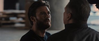 Movie still from “Wrath of Man” (2021), directed by Guy Ritchie – A person talking to another person; Close Up shot, Over the shoulder angle