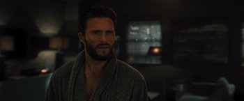 Movie still from “Wrath of Man” (2021), directed by Guy Ritchie – A person wearing a bathrobe; Close Up shot, Over the shoulder angle