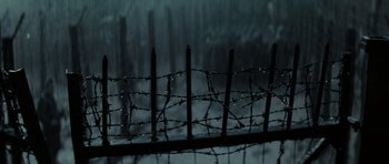 Movie still from “X-Men: First Class” (2011), directed by Matthew Vaughn – A barbed - wire fence in the middle of a rain storm; Extreme Close Up shot, High angle