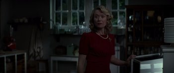 Movie still from “X-Men: First Class” (2011), directed by Matthew Vaughn – A woman in a red dress standing in front of a window; Medium shot, Low angle