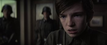 Movie still from “X-Men: First Class” (2011), directed by Matthew Vaughn – A man in a uniform and a woman in a military uniform; Close Up shot, Over the shoulder angle