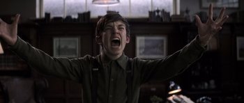 Movie still from “X-Men: First Class” (2011), directed by Matthew Vaughn – A young boy with his mouth wide open and his hands in the air; Medium shot, Low angle