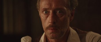 Movie still from “X-Men: First Class” (2011), directed by Matthew Vaughn – A person wearing a white shirt; Close Up shot, Over the shoulder angle