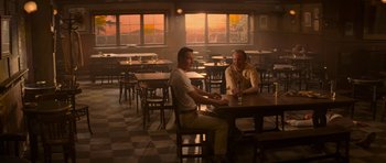 Movie still from “X-Men: First Class” (2011), directed by Matthew Vaughn – Two men sitting at a table in front of a window; Wide shot, Over the shoulder angle