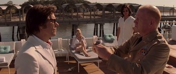 Movie still from “X-Men: First Class” (2011), directed by Matthew Vaughn – Two women and a man sitting on a deck; Medium shot, Over the shoulder angle