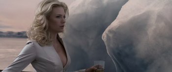 Movie still from “X-Men: First Class” (2011), directed by Matthew Vaughn – A woman holding a glass of water in front of a white elephant; Medium shot, Low angle