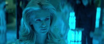 Movie still from “X-Men: First Class” (2011), directed by Matthew Vaughn – A beautiful blonde haired woman in a neon blue light; Close Up shot, Over the shoulder angle