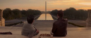 Movie still from “X-Men: First Class” (2011), directed by Matthew Vaughn – Two men are playing chess on the steps of the lincoln memorial; Wide shot, Over the shoulder angle