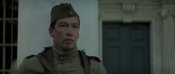 Movie still from “X-Men: First Class” (2011), directed by Matthew Vaughn – A man in a military uniform standing in front of a building; Close Up shot, Low angle