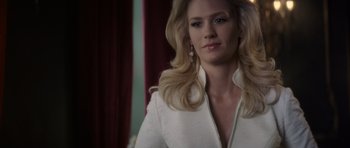 Movie still from “X-Men: First Class” (2011), directed by Matthew Vaughn – A woman with long blonde hair wearing a white jacket; Close Up shot, Over the shoulder angle