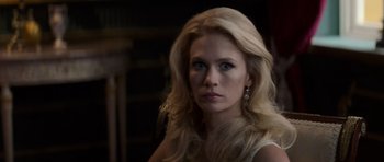 Movie still from “X-Men: First Class” (2011), directed by Matthew Vaughn – A woman with blonde hair and blue eye shadow; Close Up shot, Low angle