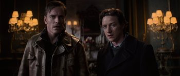 Movie still from “X-Men: First Class” (2011), directed by Matthew Vaughn – Two men standing next to each other in front of a mirror; Medium shot, Low angle