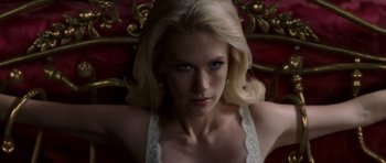 Movie still from “X-Men: First Class” (2011), directed by Matthew Vaughn – A woman with blonde hair wearing a white top; Close Up shot, High angle