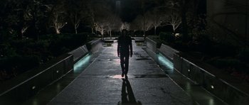 Movie still from “X-Men: First Class” (2011), directed by Matthew Vaughn – A man walking down a sidewalk at night; Wide shot, High angle