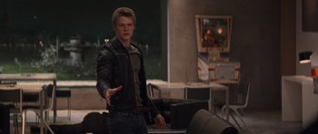 Movie still from “X-Men: First Class” (2011), directed by Matthew Vaughn – A young man in a black leather jacket holding out his hand; Medium shot, Over the shoulder angle