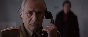 Movie still from “X-Men: First Class” (2011), directed by Matthew Vaughn – An older man holding a phone up to his ear; Close Up shot, Low angle