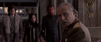Movie still from “X-Men: First Class” (2011), directed by Matthew Vaughn – A group of people standing next to each other in a room; Medium shot, Over the shoulder angle