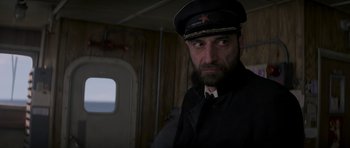 Movie still from “X-Men: First Class” (2011), directed by Matthew Vaughn – A man wearing a hat and a tie; Close Up shot, Low angle