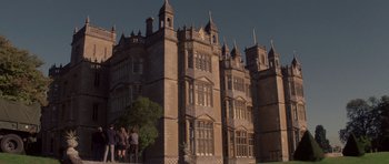 Movie still from “X-Men: First Class” (2011), directed by Matthew Vaughn – A group of people standing in front of a large building; Extreme Wide shot, Low angle